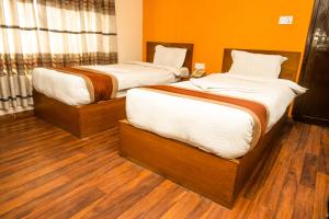 Letto o letti in una camera di Kathmandu Peace Hotel
