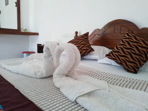 A bed or beds in a room at Nirwana Resort