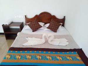 A bed or beds in a room at Nirwana Resort