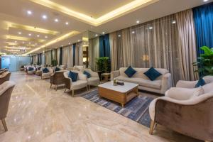 a waiting room with couches and chairs in a lobby at Paradise Inn Jeddah Hotel in Jeddah