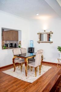 a dining room with a table and chairs at Kathy's Place in Runda in Nairobi