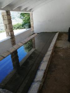 a pool of water in a building with a window at Casa Rural Maestros in Albanchez de Úbeda