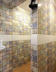 a bathroom with a shower with tiles on the wall at Рандеву in Slavske