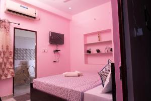 a pink room with a bed and a mirror at the new view in Jodhpur