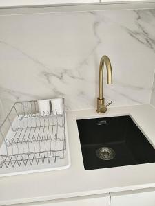 a kitchen counter with a sink and a sink at Cantinho do Castelo in Bragança