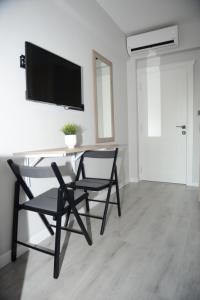 a dining room with two chairs and a table with a television at Kassimo Hotel in Istanbul