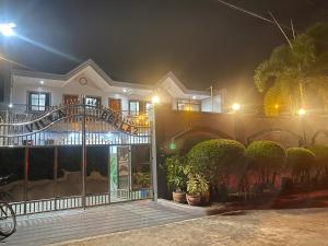 a house at night with a gate and plants at Villa Bella 2 Private Resort in Calamba