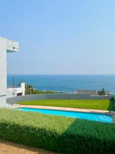 a view of a swimming pool with the ocean in the background at a V I E W or 2 in Cape Town