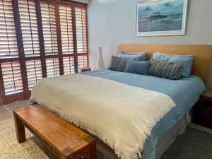 a bedroom with a large bed with a wooden headboard at a V I E W or 2 in Cape Town