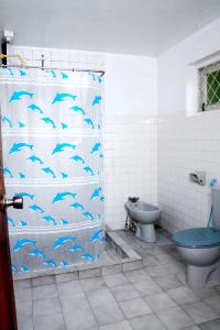 baño con cortina de ducha con delfines en The West Gate Bungalow, en Nuwara Eliya