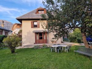 a house with a picnic table in the yard at LES BOUVREUILS in Les Deux Alpes