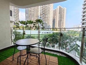 a balcony with a table and chairs and a large window at Country Garden by Antlerzone in Johor Bahru