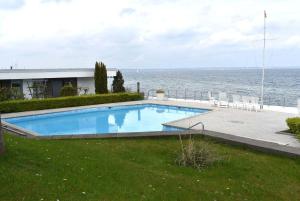 a large swimming pool next to the ocean at Haus Miramar Ferienwohnung Nr 20 in Häven