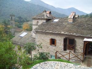an old stone house with mountains in the background at Pieve di Cà Maggiore in Firenzuola