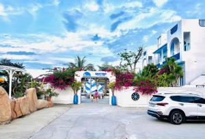 a white car parked in front of a building at Santorini Villa Cam Ranh in Cam Ranh