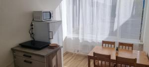 a dining room table with a microwave on top of it at Ubytovanie FUNSTAR Topoľčany in Topoľčany