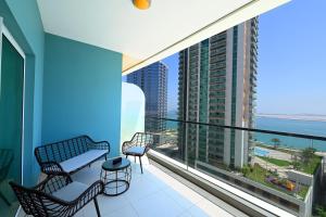 a balcony with chairs and a view of the ocean at EliteRetreat - SeaView - Gym & Pool Access - Reem Island in Abu Dhabi