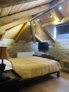 a bedroom with a large bed with wooden ceilings at Alexandros Guesthouse in Arachova