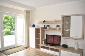 een woonkamer met een tv en een groot raam bij Lisas Nest Ferienwohnung in Timmendorfer Strand