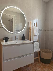 a bathroom with a sink and a mirror at La caseta del canal in Deltebre