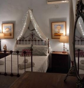 a bedroom with a bed with a canopy and lights at Aphrodite's Coast Retreat House! in Galaxidi