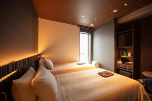 Postel nebo postele na pokoji v ubytování JHotelTokyoGEO + 21 fotografií