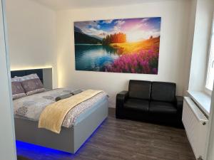 a bedroom with a bed and a painting on the wall at Tomy Apartment O2 arena PVA expo in Prague