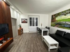 a living room with a couch and a table at O2 Aréna -PVA expo - Tomy Apartment -Praha in Prague