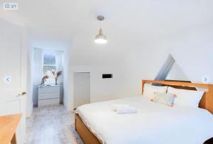 een slaapkamer met een groot wit bed en een bureau bij 2 Bedroom Brighton Apartment with Sea View in Brighton & Hove