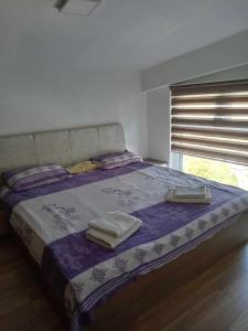 a bedroom with a large bed with two towels on it at Mavrovo Centar Ski Staza in Mavrovo