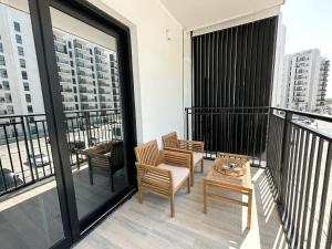 a balcony with chairs and a table on a building at Bord de l'eau 214WB8 in Abu Dhabi
