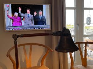- une télévision avec 4 personnes dans l'établissement Villa Wiegand - a room with a view, à Holbæk