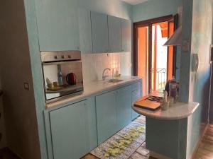 a kitchen with blue cabinets and a counter top at Il Belvedere sul Conero in Potenza Picena