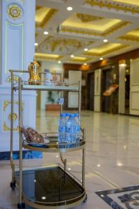 a cart with bottles of water on it in a room at فندق جيست هاوس in Yanbu