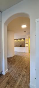 an empty room with white walls and wood floors at Ferienapartment Wilma in Grünsfeld
