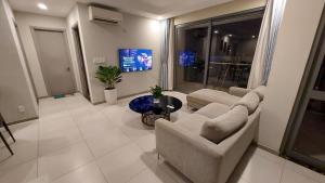 a living room with two couches and a tv at 30% promotion for Gold view apartment in the center of District 4, Ho Chi Minh, Vietnam in Ho Chi Minh City