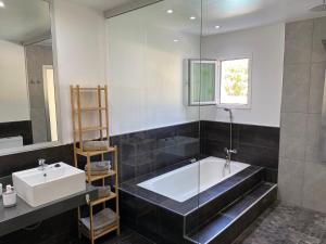 a bathroom with a bath tub and a sink at SUNNY CARMELITO DELUXE in Mogán +37 photos