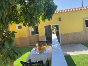 a table with fruit on it in front of a house at SUNNY CARMELITO DELUXE in Mogán