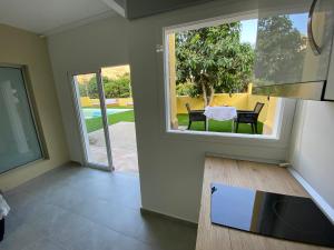 a view of a living room with a table and chairs at SUNNY CARMELITO DELUXE in Mogán