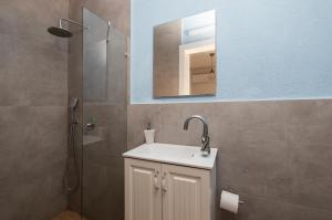 a bathroom with a sink and a shower with a mirror at Central and beautiful - MORE apartments in Beer Sheva