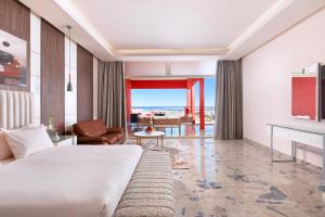 a hotel room with a bed and a living room at Pickalbatros Laguna Vista Aqua Park - Sharm El Sheikh in Sharm El Sheikh