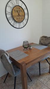a dining room table with a clock on the wall at Relaxing Beach holiday house in Hvar