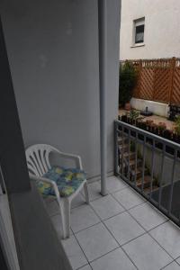 a chair sitting on the balcony of a house at Ferienwohnung Hohenlimburg in Hagen