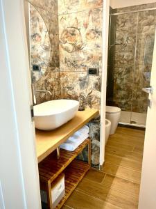 a bathroom with a sink and a shower at Opera in Sarzana