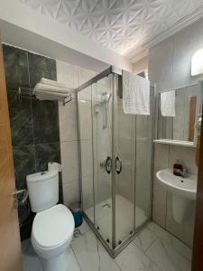 a bathroom with a shower and a toilet and a sink at The Temple Butik Otel in Kusadası