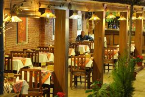 a man sitting at a table in a restaurant at Apsara Boutique Hotel in Kathmandu