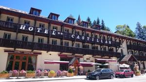 a large hotel with cars parked in front of it at Hotel Castillan in La Grave
