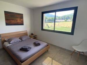 ein Schlafzimmer mit einem Bett und einem großen Fenster in der Unterkunft Magnifique Villa Sabot de Venus in Le Lautaret
