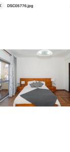 een slaapkamer met een bed en een raam bij Faustina's suite in Portimão