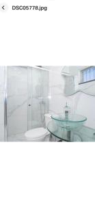 a bathroom with a glass shower and a toilet at Faustina's suite in Portimão